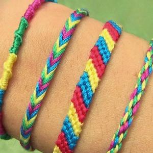 Photo of four styles of bracelets made from embroidery floss, displayed on a Caucasian wrist.