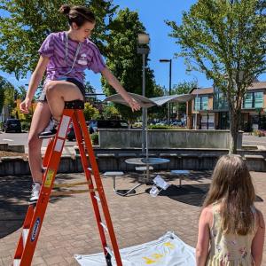 Photo of teen volunteers assisting with egg drop activity from previous science spectacular.