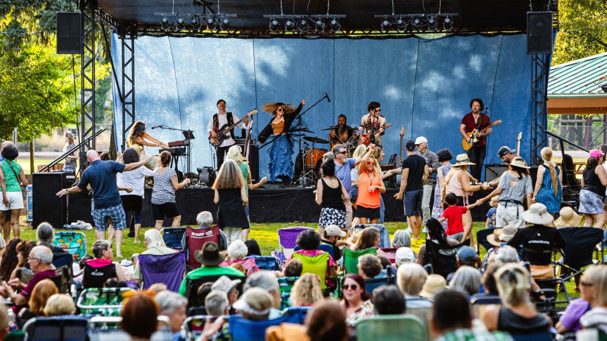 concerts photo of a crowd at a concert with performers on stage